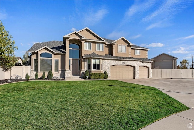 view of front of house featuring stucco siding, fence, driveway, stone siding, and a front yard