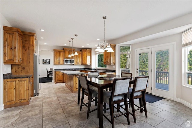 dining room featuring recessed lighting, an inviting chandelier, and plenty of natural light