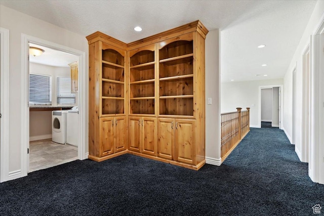 hall with recessed lighting, dark carpet, independent washer and dryer, and baseboards