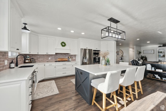 kitchen featuring a sink, white cabinetry, and stainless steel appliances