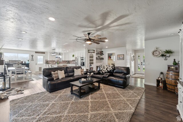 living room with recessed lighting, a ceiling fan, and dark wood-type flooring