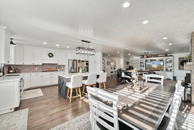 dining room with wood finished floors, recessed lighting, and a ceiling fan