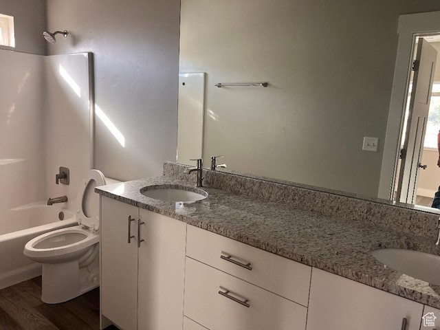 6916 N 2750 W, Honeyville, UT 84314 - full bathroom featuring washtub / shower combination, wood finished floors, toilet, and vanity