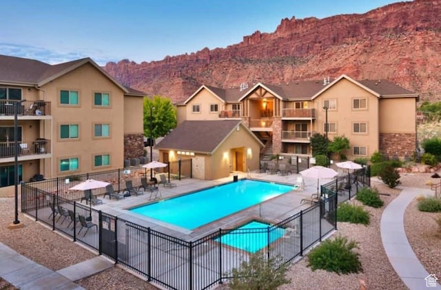 2511 Redcliff Rd Unit 1-E, Moab, UT 84532 - community pool featuring a patio area, a mountain view, and fence