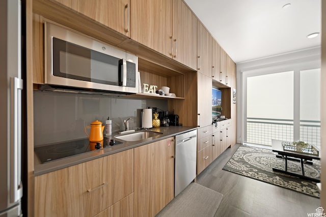 2670 Canyons Resort Dr Unit 208, Park City, UT 84098 - kitchen with stainless steel appliances, a sink, light wood finished floors, modern cabinets, and light brown cabinets