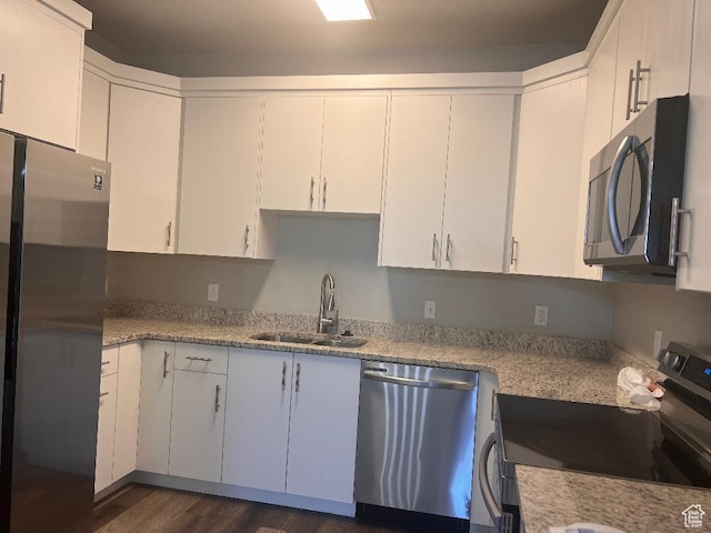 6932 N 2750 W, Honeyville, UT 84314 - kitchen with dark wood-style floors, a sink, white cabinetry, light stone countertops, and appliances with stainless steel finishes