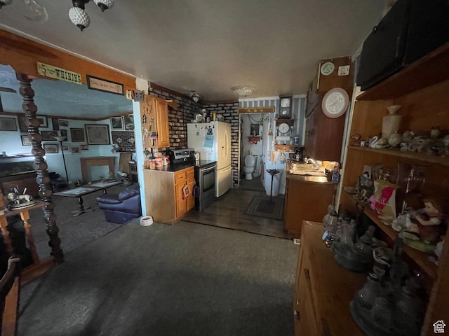 interior space featuring dark carpet, brown cabinets, and stainless steel electric range oven