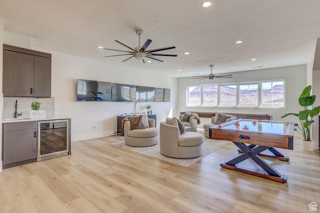 4971 S Cattail Way, Washington, UT 84780 - living area featuring baseboards, light wood-type flooring, a ceiling fan, wine cooler, and recessed lighting