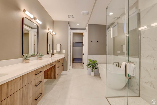 4971 S Cattail Way, Washington, UT 84780 - bathroom featuring double vanity, a shower stall, a walk in closet, visible vents, and a freestanding bath