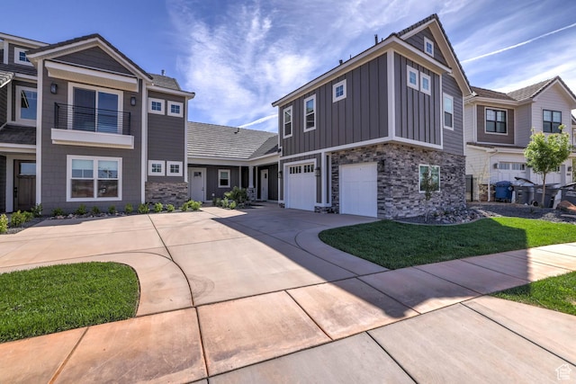 4971 S Cattail Way, Washington, UT 84780 - view of front of home with a front yard, an attached garage, stone siding, board and batten siding, and driveway