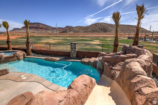4971 S Cattail Way, Washington, UT 84780 - view of swimming pool featuring a mountain view, a pool with connected hot tub, and fence
