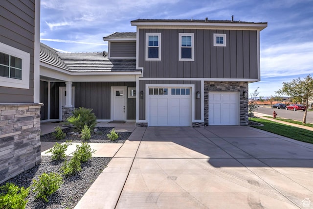 4971 S Cattail Way, Washington, UT 84780 - view of front of house featuring an attached garage, board and batten siding, concrete driveway, and stone siding