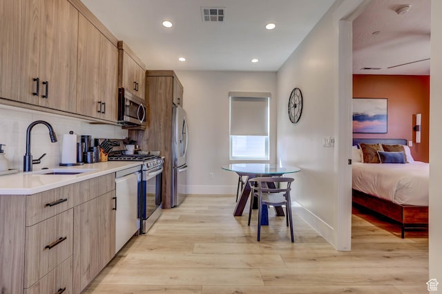 4971 S Cattail Way, Washington, UT 84780 - kitchen featuring tasteful backsplash, baseboards, visible vents, stainless steel appliances, and a sink