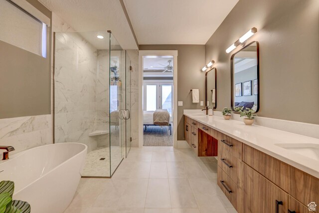 4971 S Cattail Way, Washington, UT 84780 - full bathroom with double vanity, a stall shower, ensuite bathroom, ceiling fan, and a freestanding bath