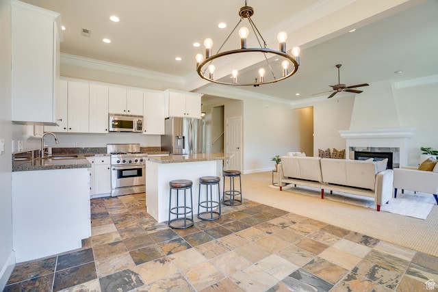 49 W Oberland Ct, Midway, UT 84049 - kitchen featuring appliances with stainless steel finishes, a sink, a ceiling fan, ornamental molding, and a center island