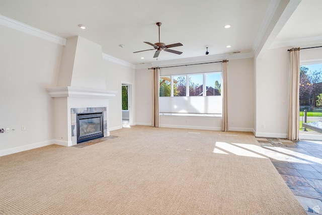 unfurnished living room with plenty of natural light, crown molding, and baseboards