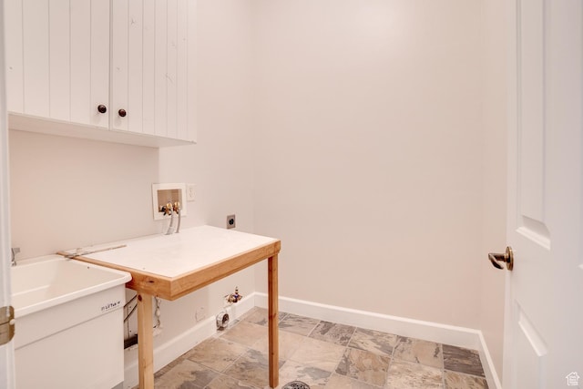laundry room with hookup for an electric dryer, gas dryer hookup, baseboards, cabinet space, and washer hookup
