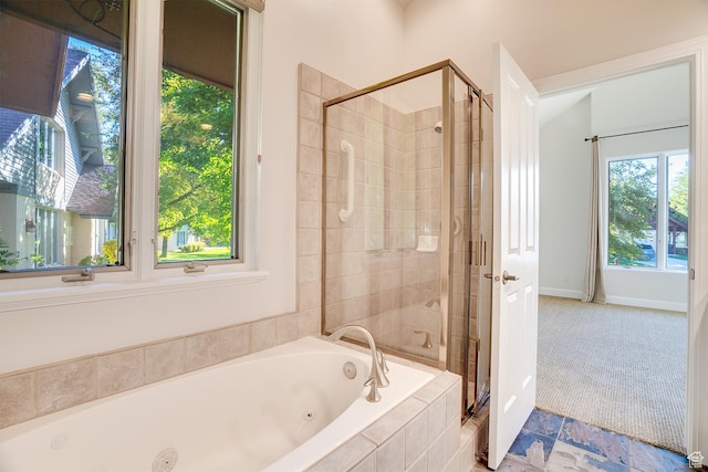 full bathroom with a stall shower, baseboards, and a tub with jets