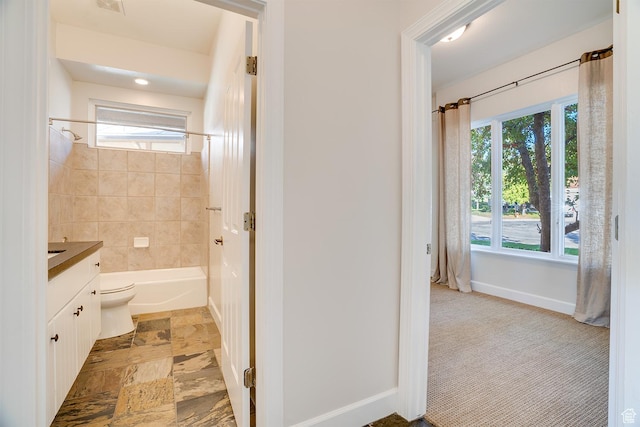 bathroom featuring baseboards, vanity, and shower / bathtub combination