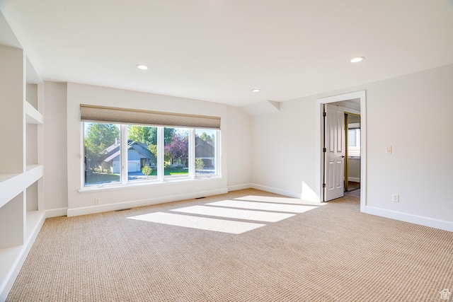 empty room with recessed lighting, baseboards, visible vents, and light colored carpet