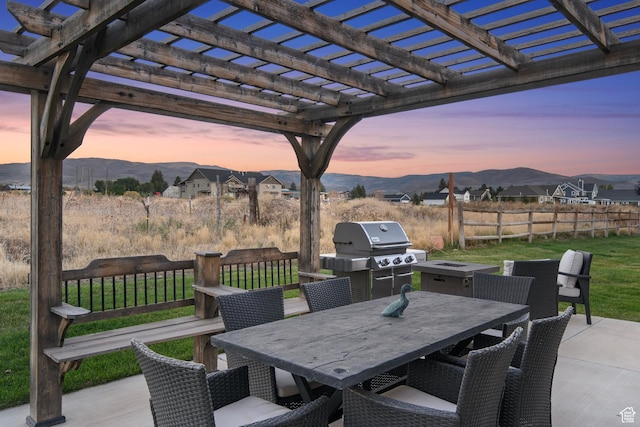 1007 S Weathervane Way, Heber City, UT 84032 - patio terrace at dusk with a pergola, outdoor dining area, fence, and a mountain view