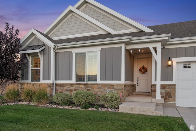 1007 S Weathervane Way, Heber City, UT 84032 - view of front facade with stone siding, an attached garage, a shingled roof, board and batten siding, and a yard