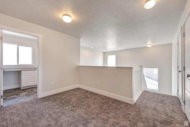 1777 S 3725th St W Unit 107, Taylor, UT 84401 - below grade area featuring carpet floors, a textured ceiling, and baseboards