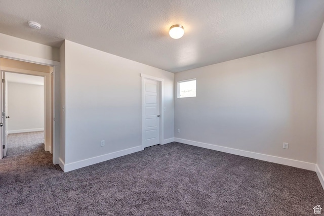 1777 S 3725th St W Unit 107, Taylor, UT 84401 - empty room featuring dark carpet, a textured ceiling, and baseboards