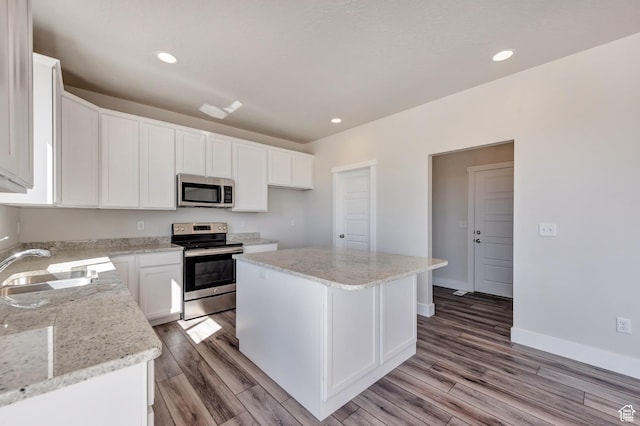 1777 S 3725th St W Unit 107, Taylor, UT 84401 - kitchen with appliances with stainless steel finishes, a sink, light wood finished floors, white cabinets, and recessed lighting