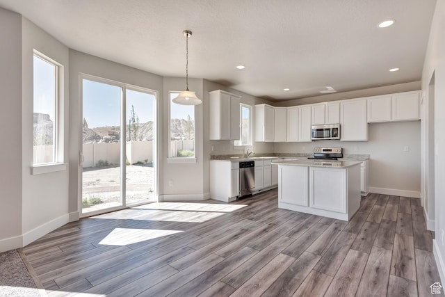 1777 S 3725th St W Unit 107, Taylor, UT 84401 - kitchen with appliances with stainless steel finishes, baseboards, light wood-style flooring, and recessed lighting