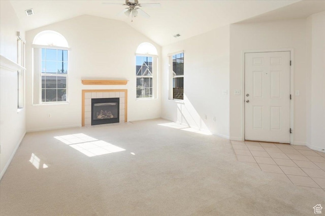 2896 W Abbey Springs Cir S, West Jordan, UT 84084 - unfurnished living room with a healthy amount of sunlight, visible vents, carpet flooring, a ceiling fan, and a tiled fireplace