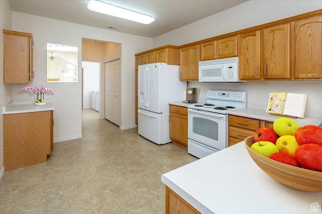 2896 W Abbey Springs Cir S, West Jordan, UT 84084 - kitchen with brown cabinetry, white appliances, light countertops, and visible vents