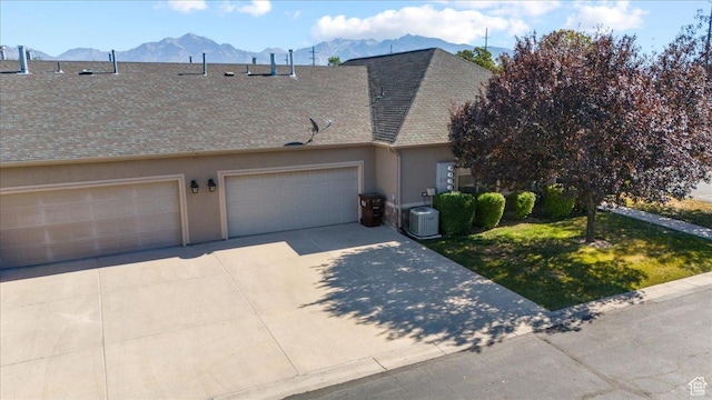 2896 W Abbey Springs Cir S, West Jordan, UT 84084 - townhome / multi-family property with a mountain view, a garage, cooling unit, stucco siding, and driveway