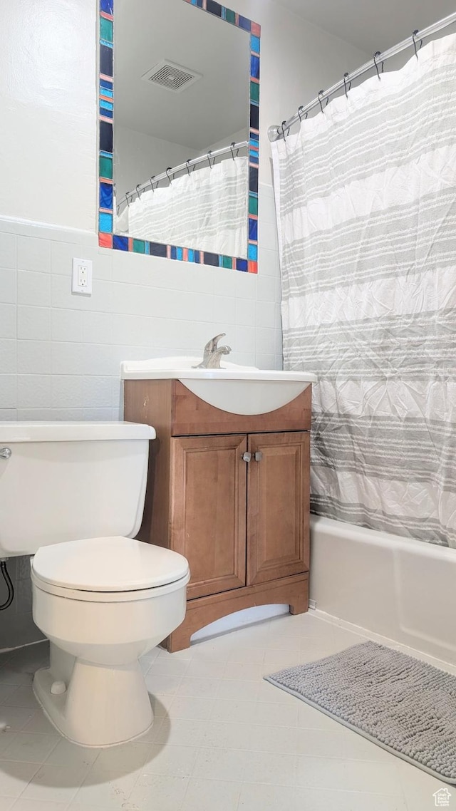 327 E Coatsville Ave S, Salt Lake City, UT 84115 - bathroom featuring tile walls, toilet, vanity, and shower / bath combo