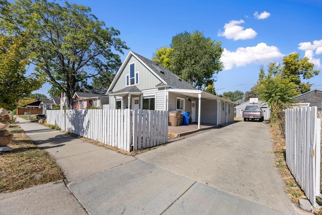 327 E Coatsville Ave S, Salt Lake City, UT 84115 - bungalow-style house with a fenced front yard, concrete driveway, and board and batten siding