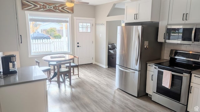 327 E Coatsville Ave S, Salt Lake City, UT 84115 - kitchen with appliances with stainless steel finishes, light wood-type flooring, a ceiling fan, and white cabinetry