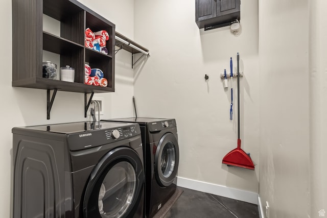 laundry area featuring cabinet space, baseboards, and separate washer and dryer