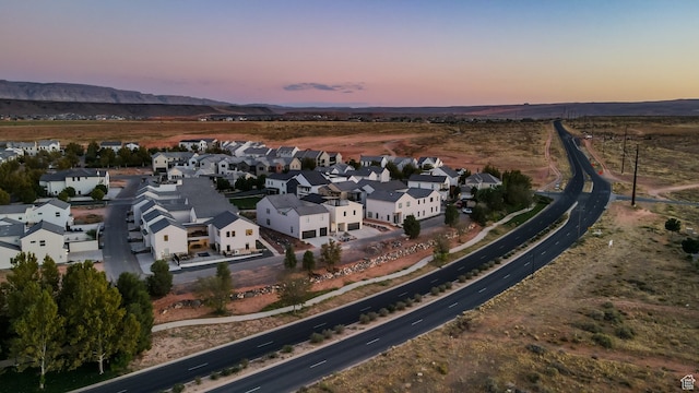 aerial view at dusk with a mountain view and a residential view