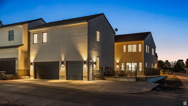 modern home featuring driveway, a garage, and stucco siding