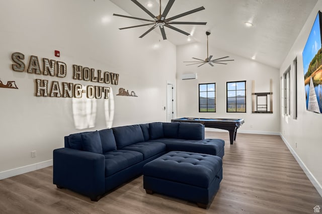 living room featuring a ceiling fan, wood finished floors, pool table, and a wall mounted air conditioner
