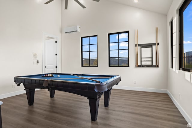 recreation room with plenty of natural light, billiards, an AC wall unit, and baseboards