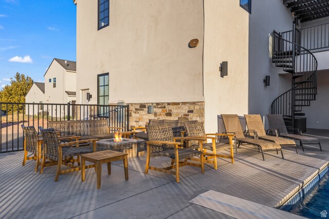 view of patio featuring a fire pit and stairs