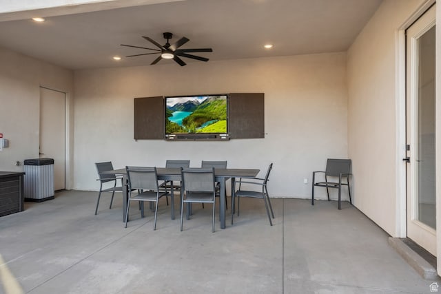view of patio with outdoor dining space and ceiling fan