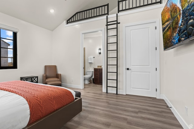 bedroom with connected bathroom, recessed lighting, wood finished floors, lofted ceiling, and baseboards