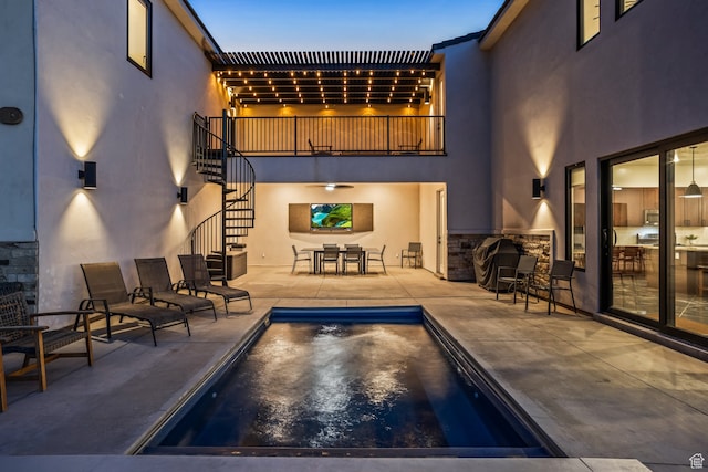 pool with stairs, a patio, and outdoor dining area