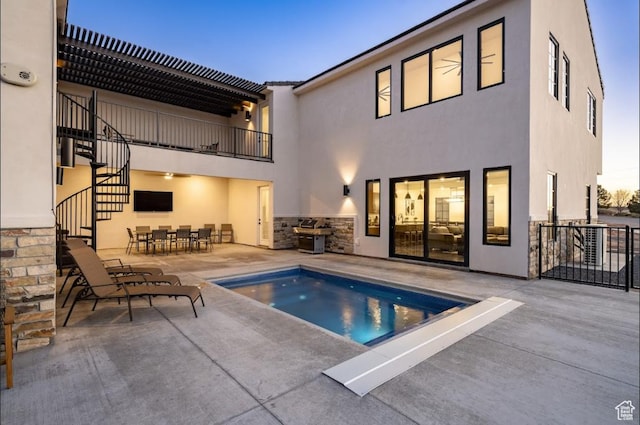 view of pool with outdoor dining space, a patio area, and stairway