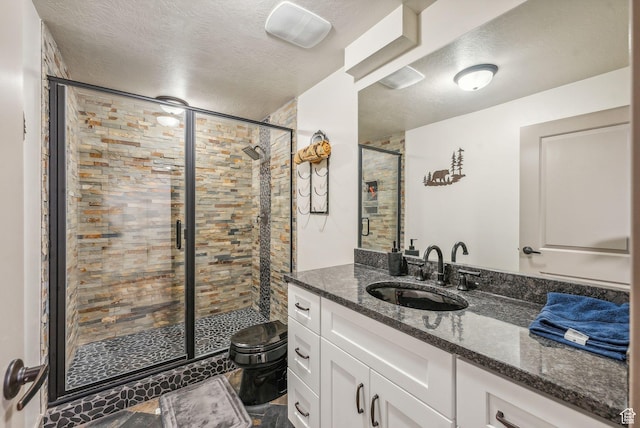 8938 N Canyon Wash Dr, Eagle Mountain, UT 84005 - full bathroom with a stall shower, a textured ceiling, toilet, and vanity