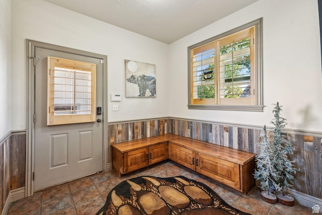 8938 N Canyon Wash Dr, Eagle Mountain, UT 84005 - entryway featuring stone finish floor, wainscoting, and wood walls