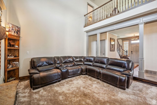 8938 N Canyon Wash Dr, Eagle Mountain, UT 84005 - living room featuring visible vents, decorative columns, a high ceiling, and stairs
