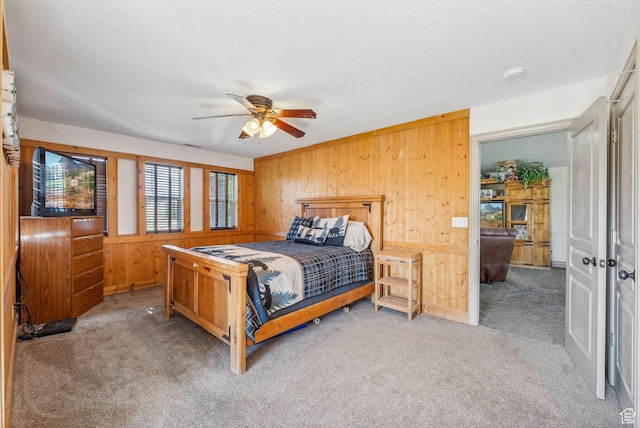 8938 N Canyon Wash Dr, Eagle Mountain, UT 84005 - bedroom with wooden walls, a ceiling fan, and light colored carpet